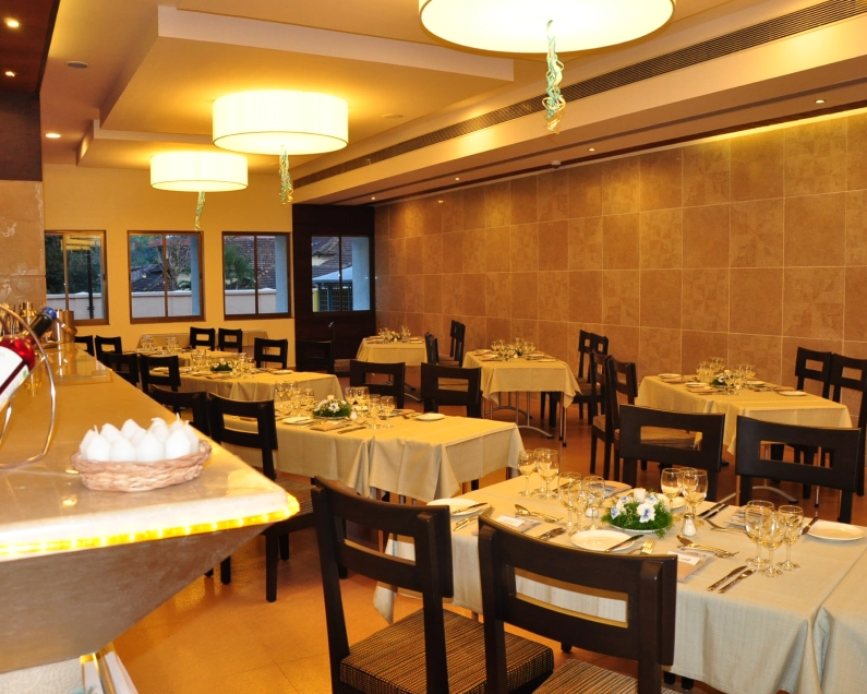 The dining room at Creams Restaurant, with tables set for service inside the VMSIIHE training hotel